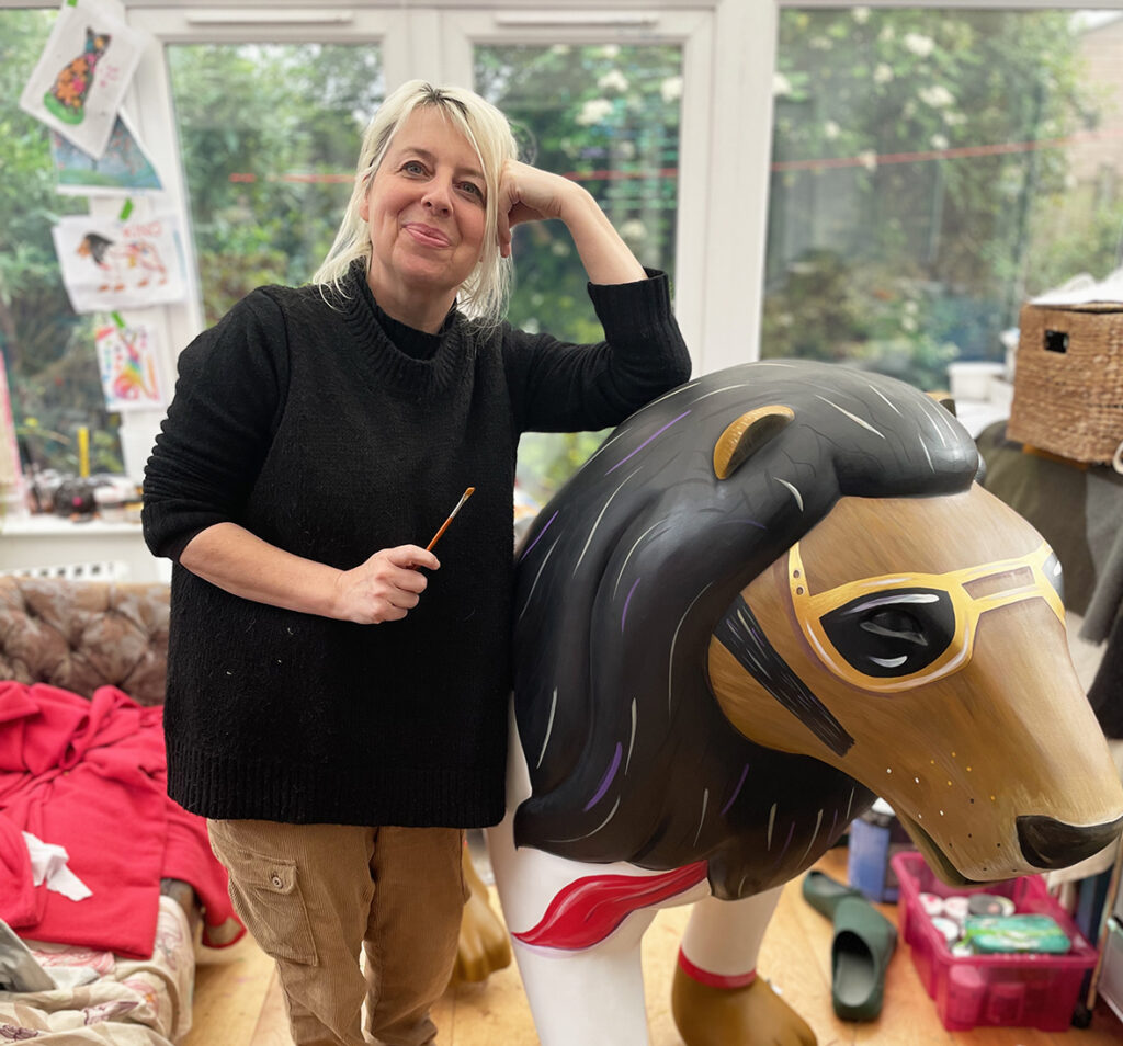 Lynne Hollingsworth poses next to 'The King' for Lions at Large 2025